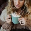 woman holding cup of hot cocoa